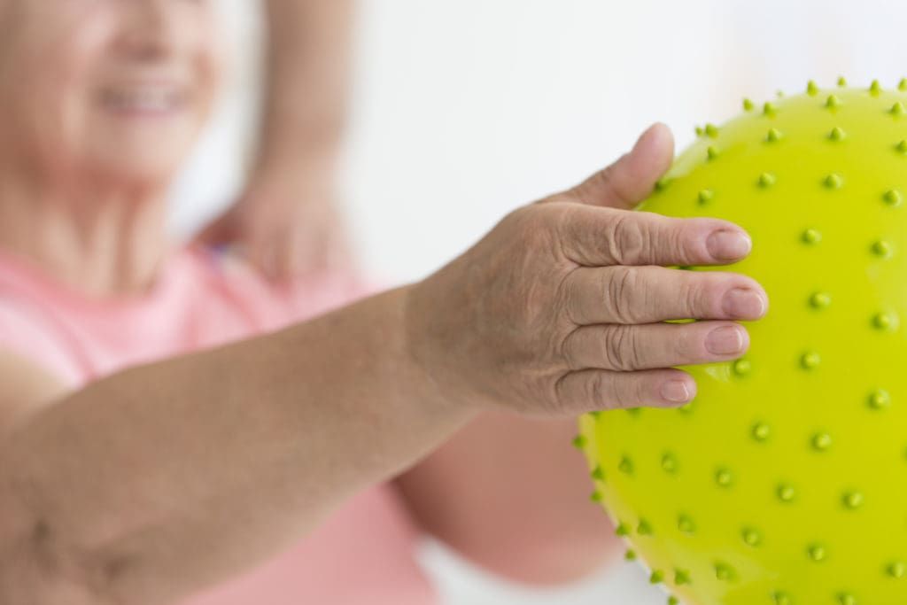 Physical therapy - Hands holding massage ball